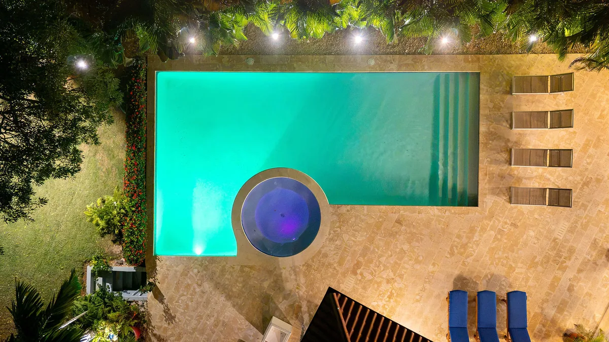 Evening aerial of the pool, jacuzzi and tree canopy