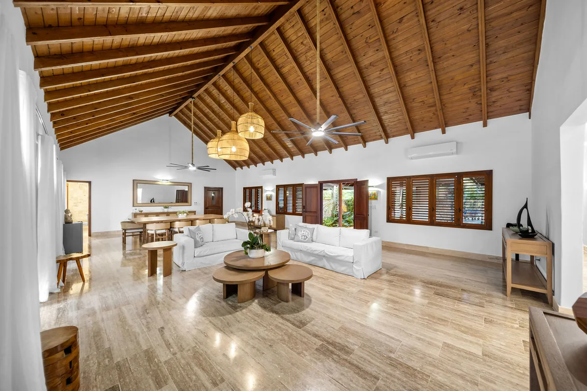 Double-height living room beneath a warm timber ceiling