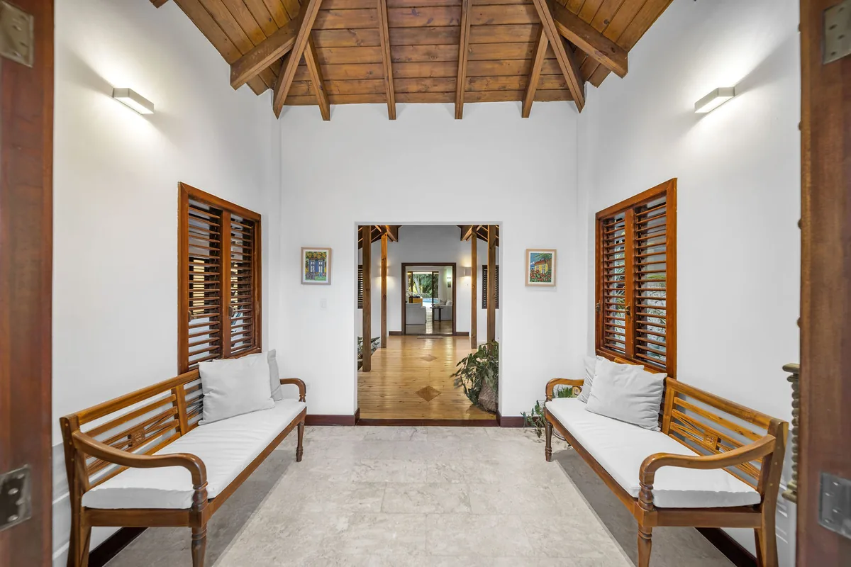 Quiet covered passage with wood-framed openings and vaulted ceiling