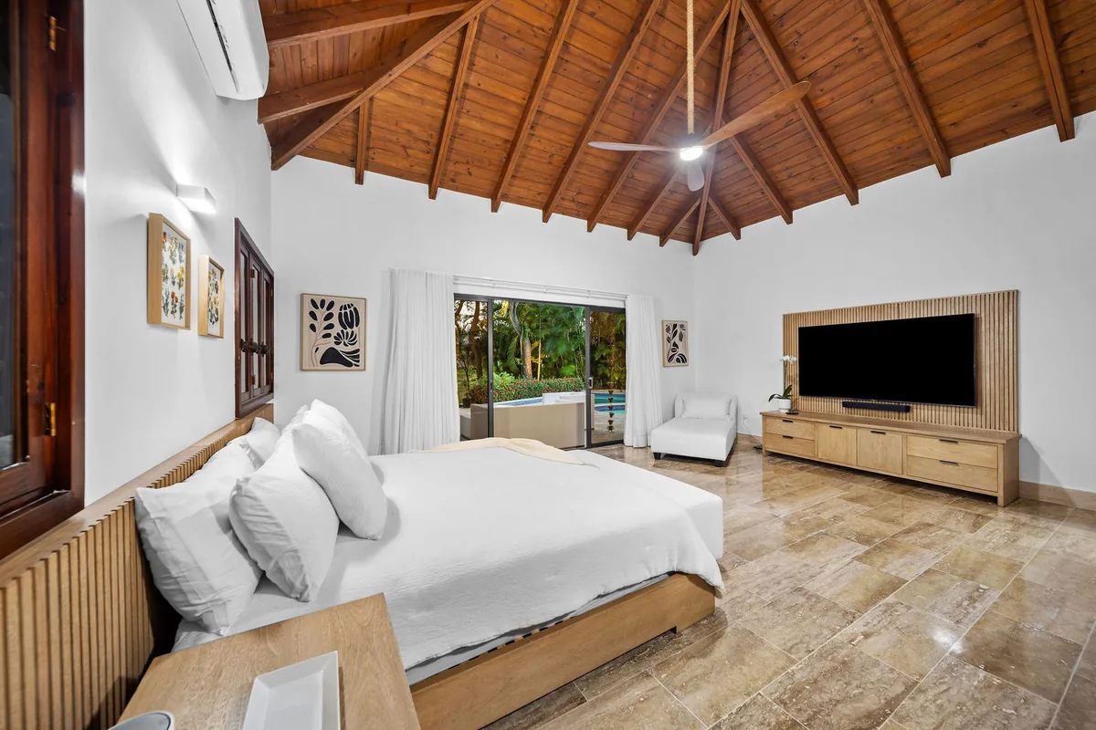 Primary bedroom opening toward a private garden sitting area