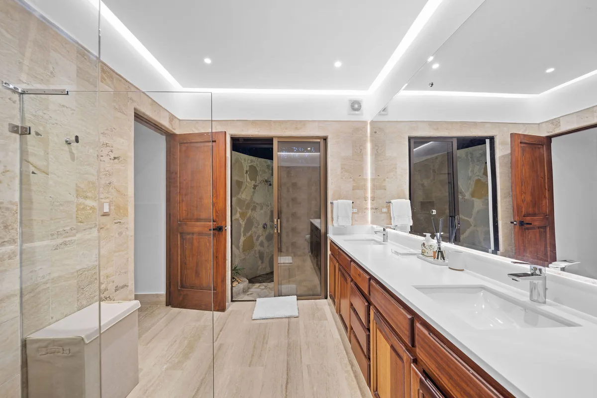 Bright bathroom with long double vanity and walk-in shower