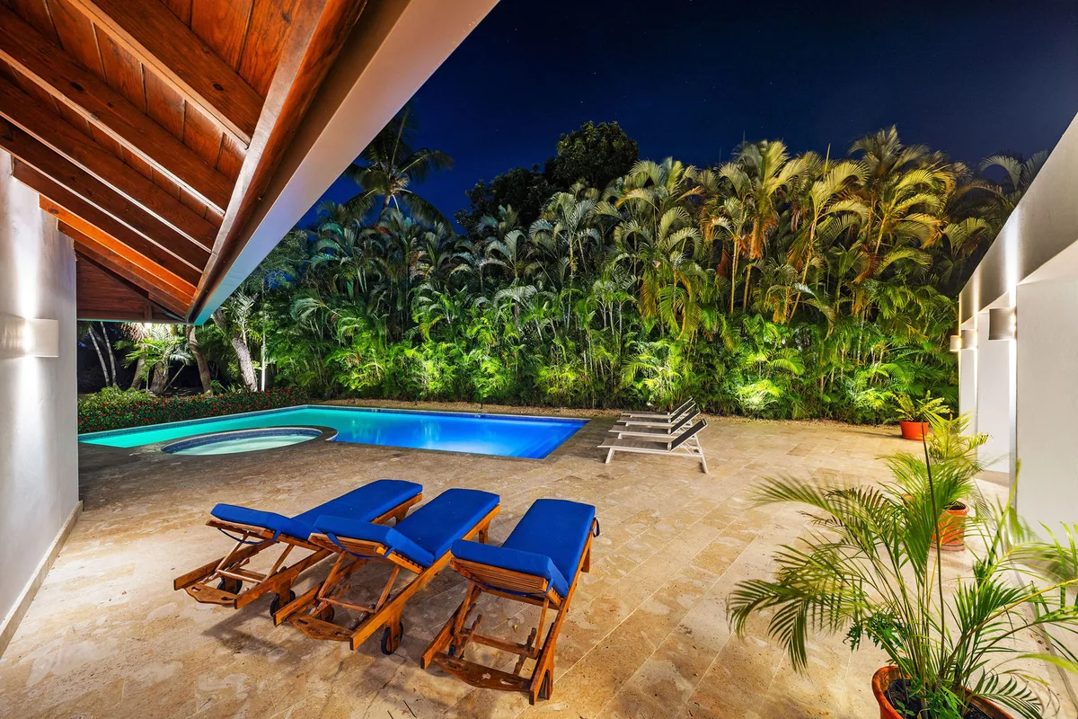 Pool terrace beneath the mature garden canopy at night